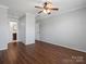 Neutral bedroom featuring hardwood floors, ceiling fan, closet and ensuite access, and ample natural light at 9404 S Vicksburg Park Ct, Charlotte, NC 28210