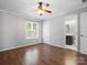 Neutral bedroom featuring hardwood floors, ceiling fan, view of ensuite, and closet at 9404 S Vicksburg Park Ct, Charlotte, NC 28210
