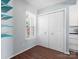 This bedroom has a large window with shelves to the left and a closet to the right at 9404 S Vicksburg Park Ct, Charlotte, NC 28210