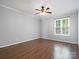 Neutral bedroom featuring hardwood floors, ceiling fan, and ample natural light at 9404 S Vicksburg Park Ct, Charlotte, NC 28210