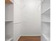Walk-in closet with organized shelves and railing, plus hardwood floors at 9404 S Vicksburg Park Ct, Charlotte, NC 28210