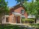 Exterior view of red brick townhome on a sunny day, with green grass at 9404 S Vicksburg Park Ct, Charlotte, NC 28210