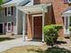 Close up of front entrance door to unit 9404 with small front yard at 9404 S Vicksburg Park Ct, Charlotte, NC 28210