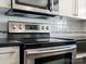 Updated kitchen with stainless steel range, tiled backsplash, and modern fixtures at 9404 S Vicksburg Park Ct, Charlotte, NC 28210