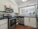 Well-lit kitchen features stainless steel appliances, white cabinets, and an open design at 9404 S Vicksburg Park Ct, Charlotte, NC 28210