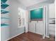 This laundry room is located right next to a window with shelves on the side at 9404 S Vicksburg Park Ct, Charlotte, NC 28210