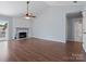 Living room with vaulted ceiling, fireplace, hardwood floors, and access to a patio at 9404 S Vicksburg Park Ct, Charlotte, NC 28210