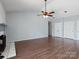 Spacious living room features hardwood floors, ceiling fan, and a cozy fireplace at 9404 S Vicksburg Park Ct, Charlotte, NC 28210