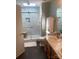 Bright bathroom featuring double sinks, a glass-enclosed shower with a bench, and tile flooring at 9612 Farmridge Ln, Matthews, NC 28105