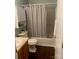 Bathroom with a vanity, toilet, and a tub/shower combination with a curtain at 9612 Farmridge Ln, Matthews, NC 28105