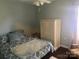 A tidy bedroom featuring wood-look flooring and furniture with storage at 9612 Farmridge Ln, Matthews, NC 28105