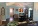 Open concept dining room with hardwood floors and stylish lighting at 9612 Farmridge Ln, Matthews, NC 28105
