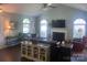 Spacious living room with vaulted ceilings, a fireplace, and ample natural light at 9612 Farmridge Ln, Matthews, NC 28105