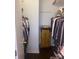 A walk-in closet with clothes and storage space featuring an antique cabinet at 9612 Farmridge Ln, Matthews, NC 28105