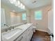 Bright bathroom featuring double sinks, granite countertops, and modern fixtures for a spa-like experience at 111 W Perry St, Heath Springs, SC 29058