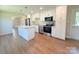 Modern kitchen with stainless appliances, granite counters, and an island, perfect for cooking and entertaining at 111 W Perry St, Heath Springs, SC 29058