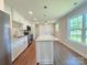 Modern kitchen boasting stainless steel appliances, an island, and plenty of white cabinetry for ample storage at 111 W Perry St, Heath Springs, SC 29058