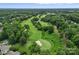 Scenic aerial view overlooking a golf course with verdant fairways, mature trees, and manicured greens at 11917 Ulsten Ln, Huntersville, NC 28078