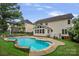 A backyard featuring a pool, patio, seating, and an outdoor grill at 11917 Ulsten Ln, Huntersville, NC 28078