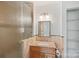 Bathroom featuring a glass shower and granite countertops with a view to additional shelving at 11917 Ulsten Ln, Huntersville, NC 28078