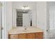 Well-lit bathroom with a large mirror, vanity, and sink at 11917 Ulsten Ln, Huntersville, NC 28078