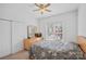 Cozy bedroom featuring a floral comforter, window with blinds, and closet at 11917 Ulsten Ln, Huntersville, NC 28078