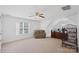 Spacious bonus room with a ceiling fan, window, carpet, and furniture at 11917 Ulsten Ln, Huntersville, NC 28078