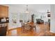 Charming breakfast area with hardwood floors, a cozy table, and a view to the sunroom and living room at 11917 Ulsten Ln, Huntersville, NC 28078
