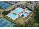 Aerial view of community pool area with multiple pools, seating, playgrounds and tennis courts at 11917 Ulsten Ln, Huntersville, NC 28078