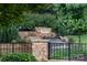 Stone monument featuring the 'Northstone Country Club' sign with a tranquil waterfall feature and lush landscaping at 11917 Ulsten Ln, Huntersville, NC 28078