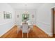Elegant dining room with hardwood floors, chandelier, and large window offering ample natural light at 11917 Ulsten Ln, Huntersville, NC 28078