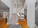 Grand foyer with hardwood floors, staircase and decorative rug, creating an inviting entry at 11917 Ulsten Ln, Huntersville, NC 28078