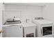 Bright laundry room equipped with modern washer, dryer, and sink at 11917 Ulsten Ln, Huntersville, NC 28078