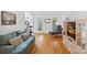Spacious living room with hardwood floors, a comfortable sofa, and large windows for natural light at 11917 Ulsten Ln, Huntersville, NC 28078