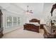 Spacious bedroom with a tray ceiling, large bed, and natural light from the window at 11917 Ulsten Ln, Huntersville, NC 28078