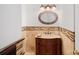 Elegant powder room with a marble countertop vanity and decorative mirror at 11917 Ulsten Ln, Huntersville, NC 28078