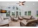 Bright sun room with wicker furniture, tile floor, large windows, and backyard views at 11917 Ulsten Ln, Huntersville, NC 28078
