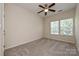 Bright, carpeted bedroom with a ceiling fan, double windows, and neutral walls offering a calming retreat at 1329 Jacemans Way, Cornelius, NC 28031