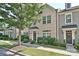 Charming brick townhome with a well-manicured lawn and lush landscaping at 1329 Jacemans Way, Cornelius, NC 28031