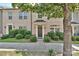 Inviting brick townhome featuring tidy shrubs and a welcoming front entrance at 1329 Jacemans Way, Cornelius, NC 28031