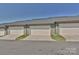 View of multiple attached garages with neutral doors and siding at 1329 Jacemans Way, Cornelius, NC 28031