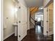 Open hallway with hardwood floors and staircase to the second level at 1329 Jacemans Way, Cornelius, NC 28031