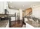 Well-lit kitchen with granite counters, stainless steel appliances, and a tile backsplash at 1329 Jacemans Way, Cornelius, NC 28031
