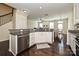 Open-concept kitchen with stainless steel dishwasher and granite countertops at 1329 Jacemans Way, Cornelius, NC 28031