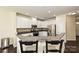 Bright kitchen with white cabinets, granite countertops, and stainless steel appliances at 1329 Jacemans Way, Cornelius, NC 28031