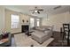 Open living room with a fireplace, a ceiling fan, and natural light at 1329 Jacemans Way, Cornelius, NC 28031