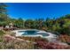 Community pool with a partial cover surrounded by trees and vegetation at 1329 Jacemans Way, Cornelius, NC 28031