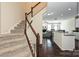 Staircase leading to kitchen with modern appliances and granite countertops at 1329 Jacemans Way, Cornelius, NC 28031