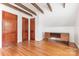 Attic bonus room features desk, storage, exposed beams, and hardwood floors at 1400 Matheson Ave, Charlotte, NC 28205
