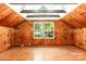 Attic bonus room showcases knotty pine paneling, exposed beams, and natural light at 1400 Matheson Ave, Charlotte, NC 28205